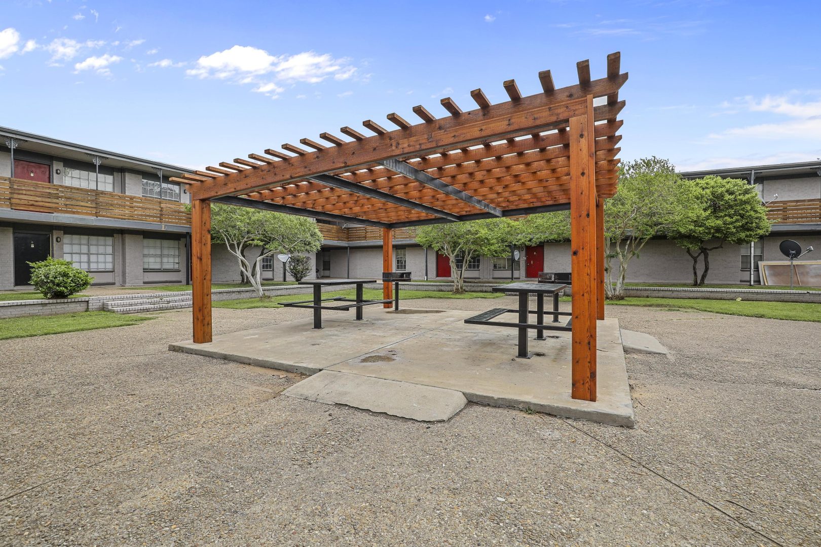 a picnic table in an outdoor area with a pergol at The Flats on Handley