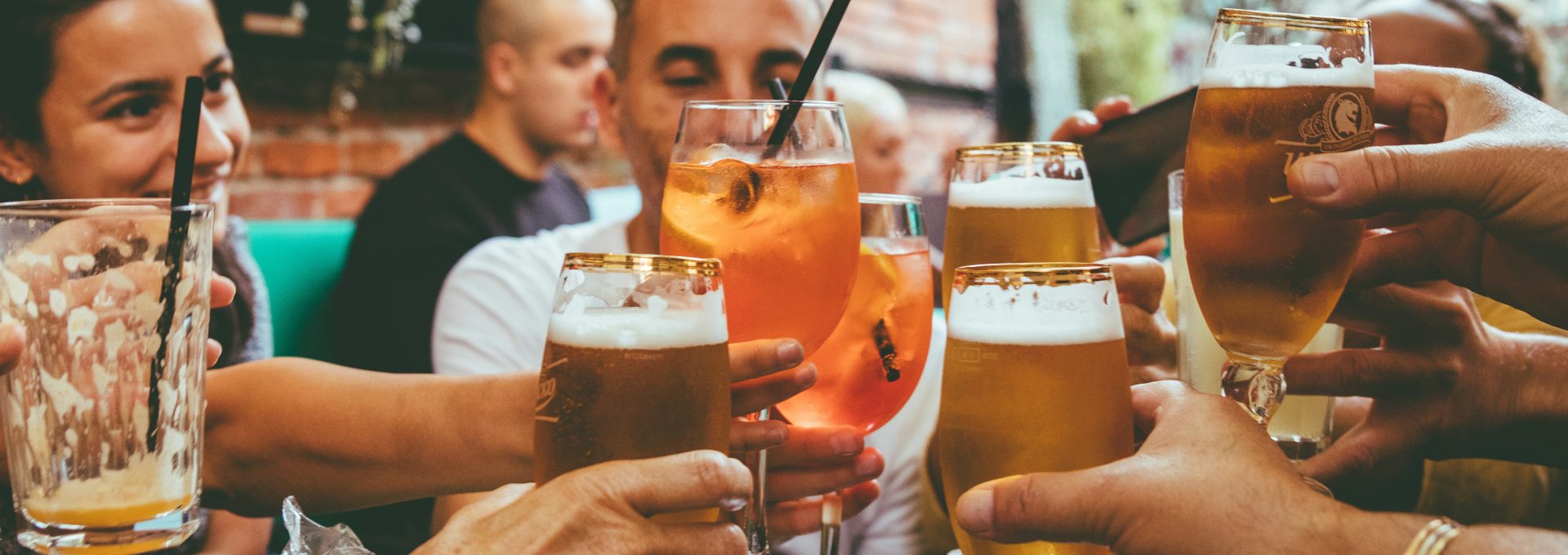 people holding drinks during day