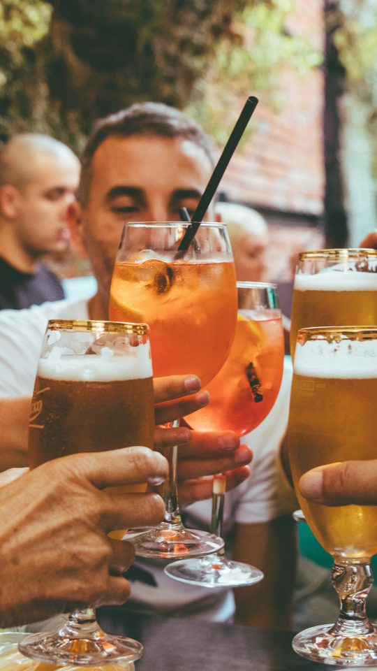 people holding drinks during day